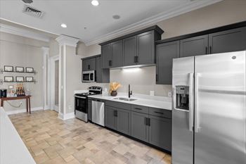 A modern kitchen with a refrigerator on the right.